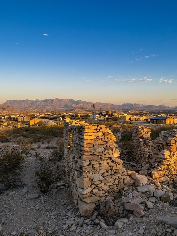 Terlingua ghost town ruins with the Big Bend mountains in the distance at golden hour